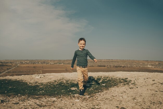 Pequeño muchacho caucásico joven en la naturaleza, infancia