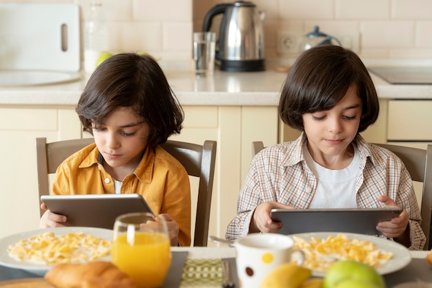 Pequeños gemelos jugando en su tableta