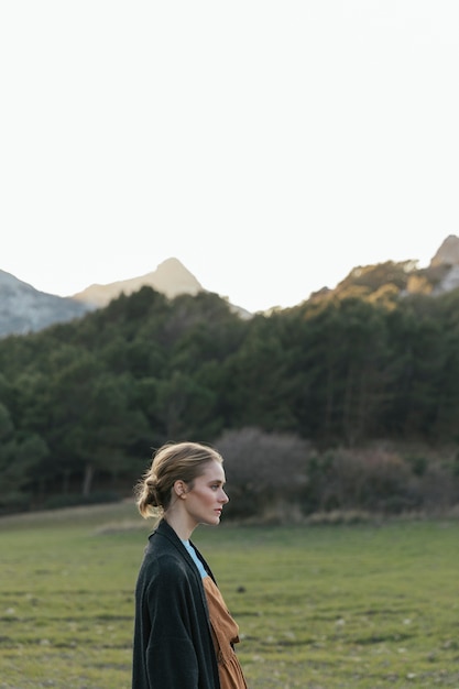 Perfil lateral de mujer con paisaje