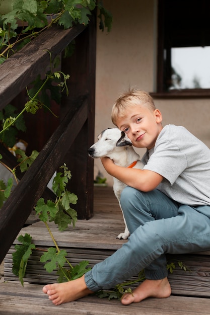 Foto gratuita perro de explotación de niño de tiro medio