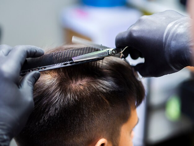 Persona con guantes y nuevo corte de pelo.