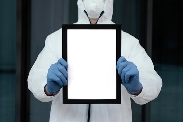 Foto gratuita persona con máscara médica sosteniendo una tableta en blanco