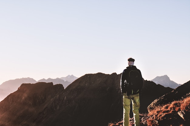 Foto gratuita persona de pie en la cima de la montaña