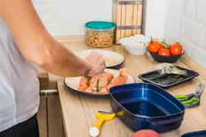 Foto gratuita persona poniendo pescado en un plato