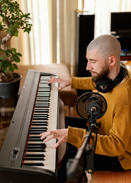 Foto gratuita persona que produce música en casa