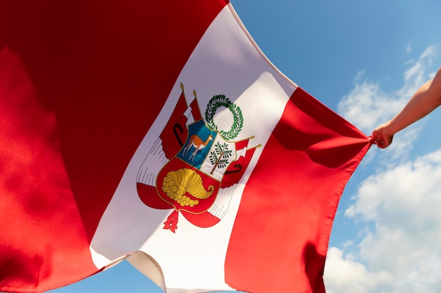 Persona sosteniendo la bandera de Perú al aire libre