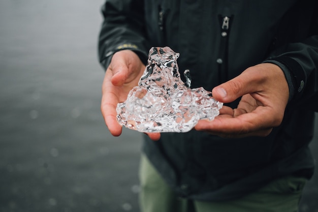 Persona sostiene un trozo de hielo glaciar en islandia