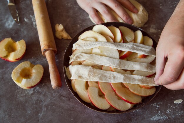 Persona vista superior haciendo una tarta de manzana