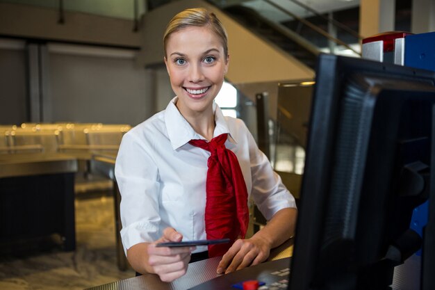 Personal femenino sonriente en la terminal del aeropuerto