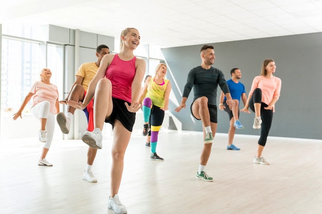 Personas activas que participan juntas en la clase de zumba.