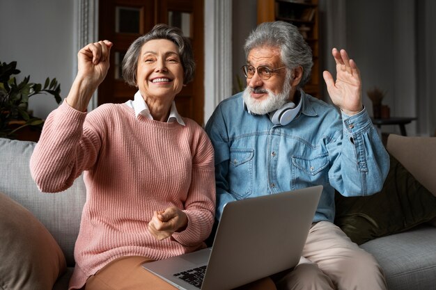 Personas mayores de tiro medio con laptop