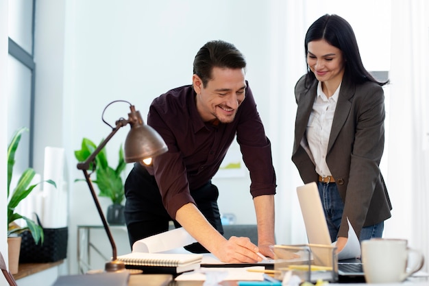 Personas sonrientes de tiro medio trabajando juntas