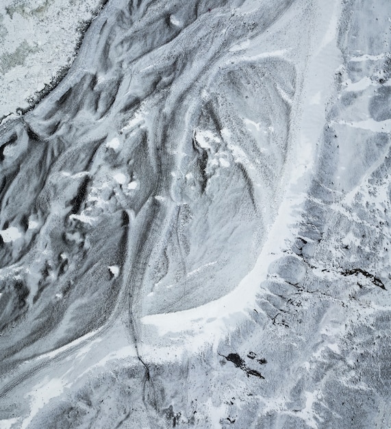 Perspectiva aérea de arriba hacia abajo del camino helado que conduce a la base del glaciar Sólheimajökull