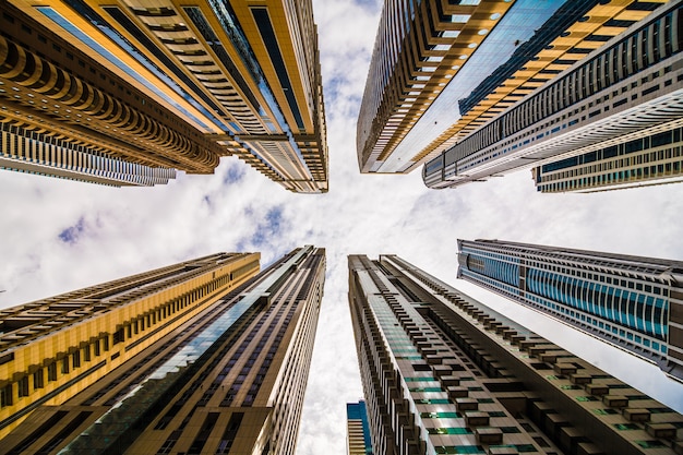 Perspectiva espectacular con vista de ángulo bajo de rascacielos mirando hacia el cielo, Dubai. Punto de fuga