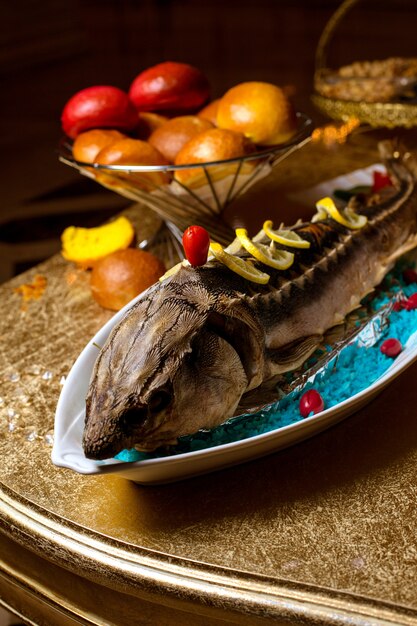 Pescado frito con rodajas de limón sobre la mesa