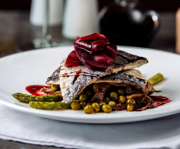 Pescado frito con verduras sobre la mesa