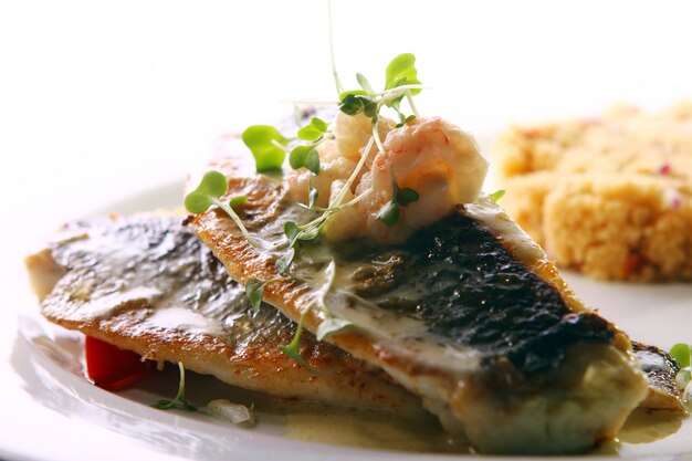 Pescado a la parrilla gourmet servido con langostinos