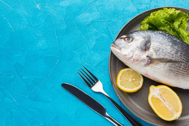 Pescado plano con limón en un plato