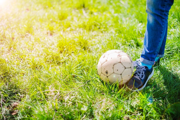 Piernas con un balón al aire libre