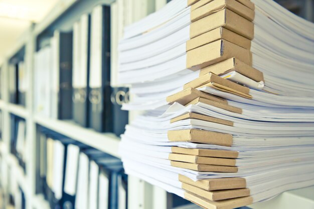 Carpeta de documentos apilados en el estante en la sala de