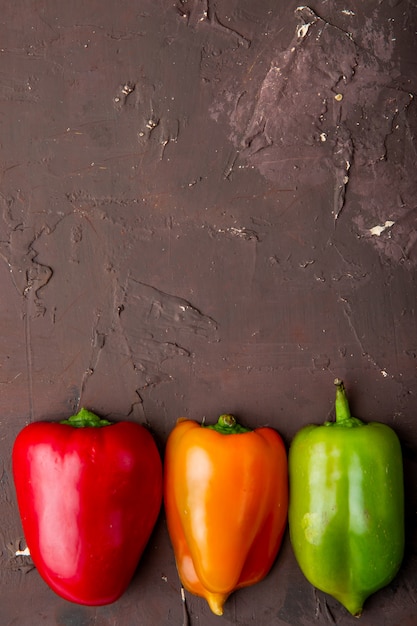 Foto gratuita pimientos enteros en mesa granate