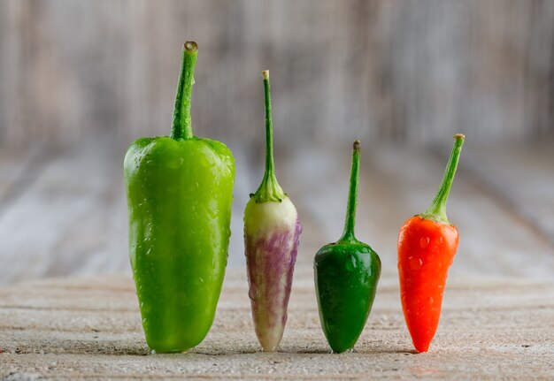 Pimientos en tabla de cortar y madera.