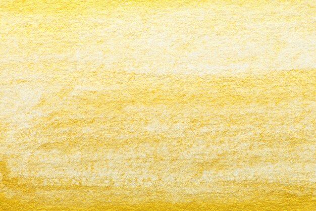 Pintura de acuarela abstracta de oro amarillo con textura sobre papel blanco