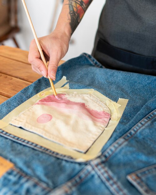 Pintura a mano de primer plano en pieza de ropa