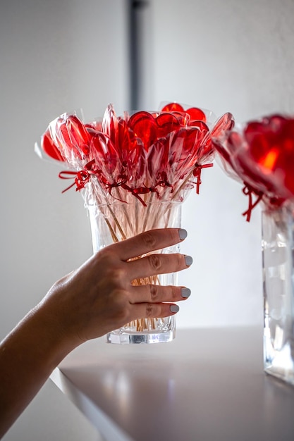 Piruletas rojas en forma de corazón en el mostrador de una tienda de golosinas