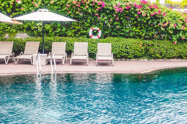 Foto gratuita piscina con hamacas detras