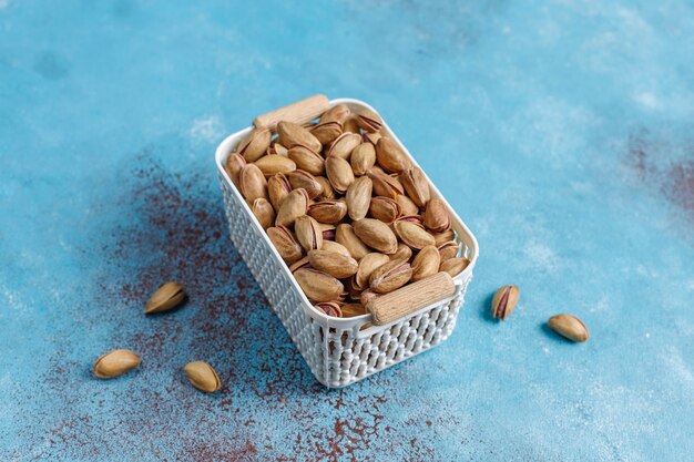 Pistachos tostados salados en cáscara de nuez.