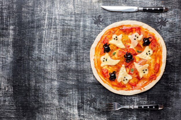 Pizza de Halloween con fantasmas y cubiertos