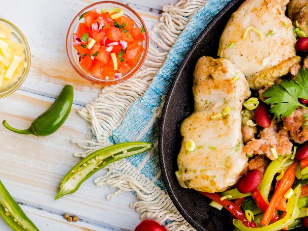 Placa de pollo frito con verduras y salsa.