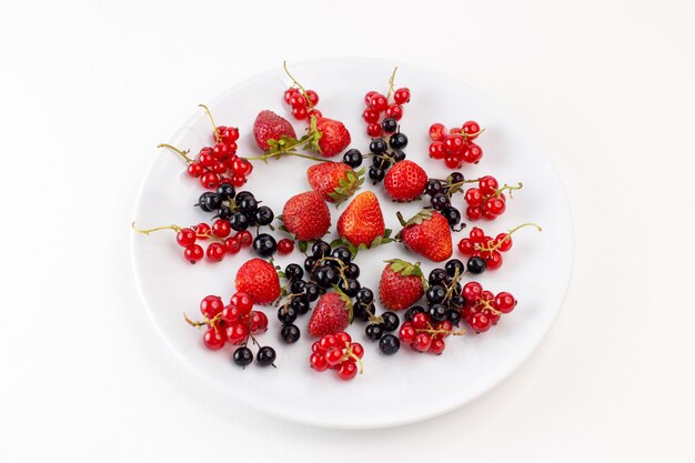 Placa de vista superior con fresas frescas y suaves con arándanos en el fondo blanco color baya de fruta fresca suave
