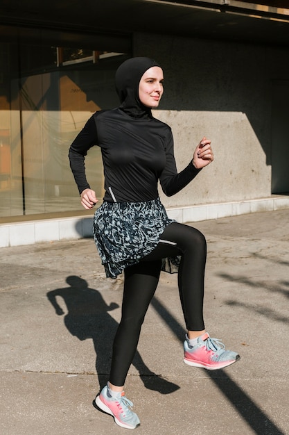 Plano completo de mujer con entrenamiento de hijab