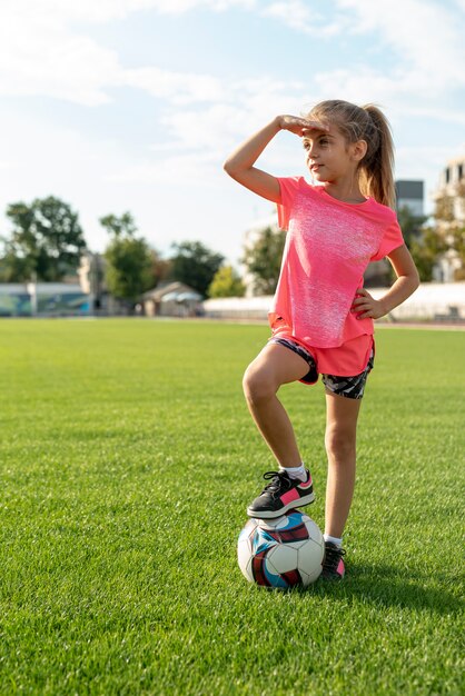 Plano completo de niña en camiseta rosa