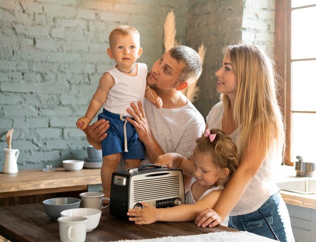 Foto gratuita plano medio familia feliz en la cocina