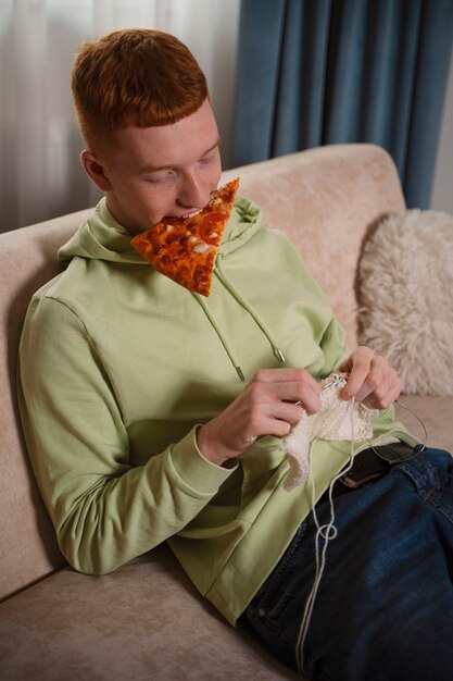 Plano medio hombre comiendo y tejiendo