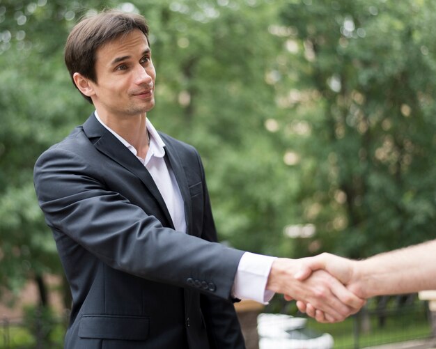 Plano medio de hombres dándose la mano