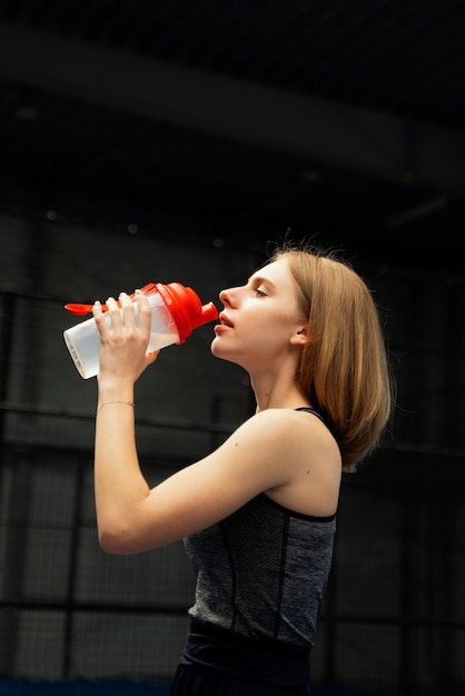 Plano medio de mujer agua potable