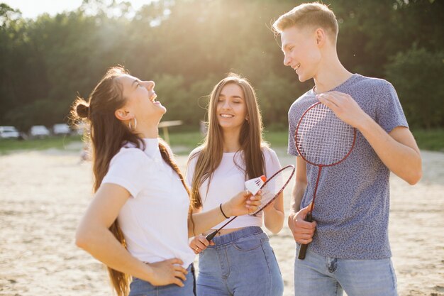 Plano medio riendo amigos de pie al aire libre