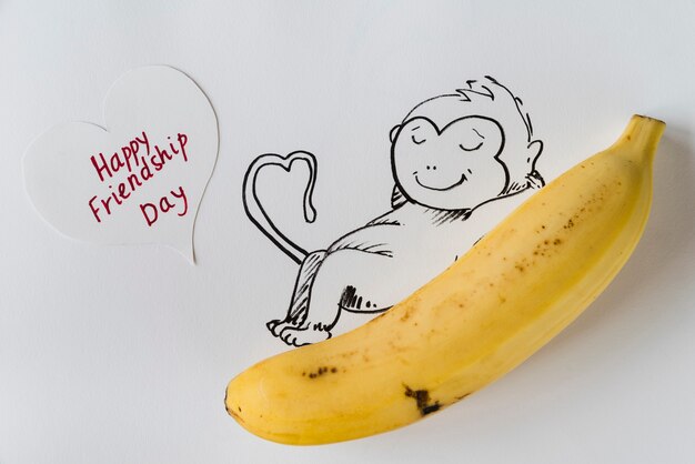 Plátano con mono pintado y tarjeta de felicitación.
