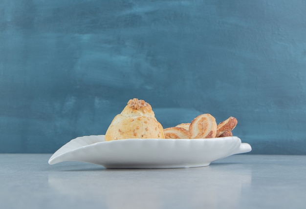 Un plato blanco lleno de deliciosas galletas dulces con azúcar.