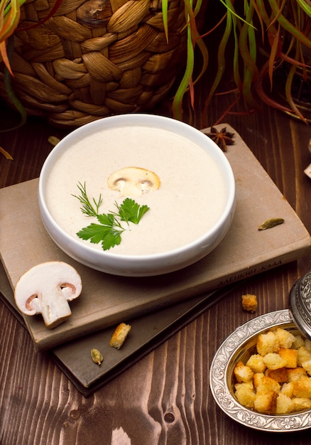 Un plato de deliciosa crema casera de sopa de champiñones con pan tostado.