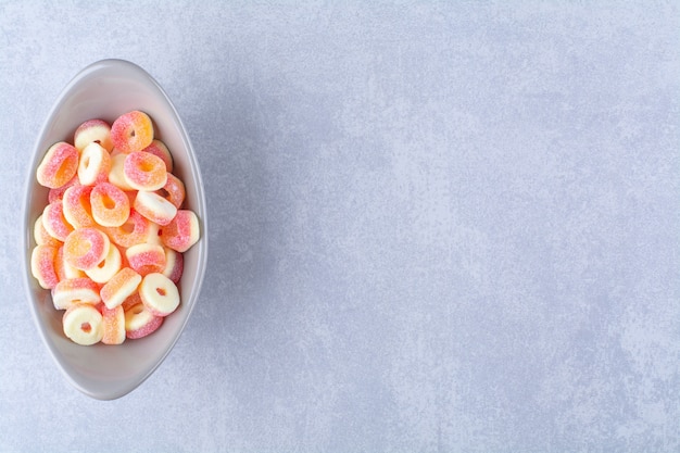Un plato hondo lleno de mermeladas azucaradas de frutas coloridas. Foto de alta calidad
