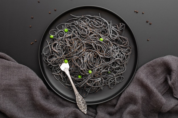 Plato de pasta oscura sobre un paño oscuro