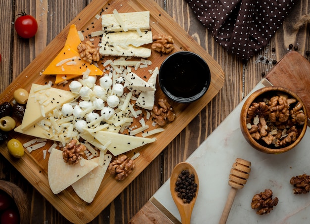 Plato de queso con aceitunas y nueces.