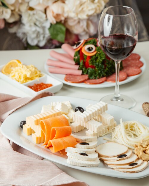Plato de queso con vista lateral de vino tinto