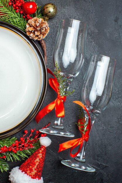 Platos de cena accesorios de decoración ramas de abeto calcetín de navidad copas de cristal de árbol de navidad en la mesa oscura