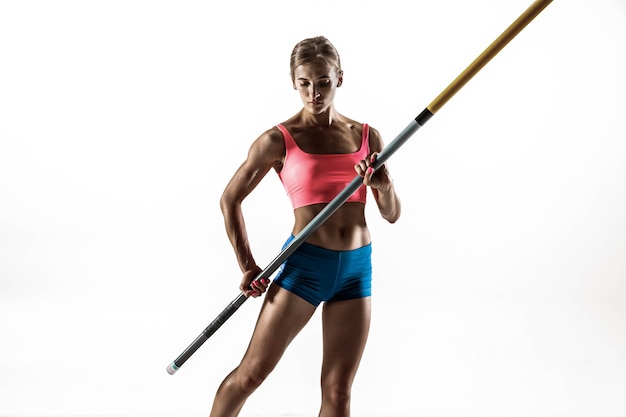 Foto gratuita poder, belleza y pureza. formación profesional de salto con pértiga femenina en la pared blanca. modelo femenino en forma y delgada practicando. concepto de deporte,